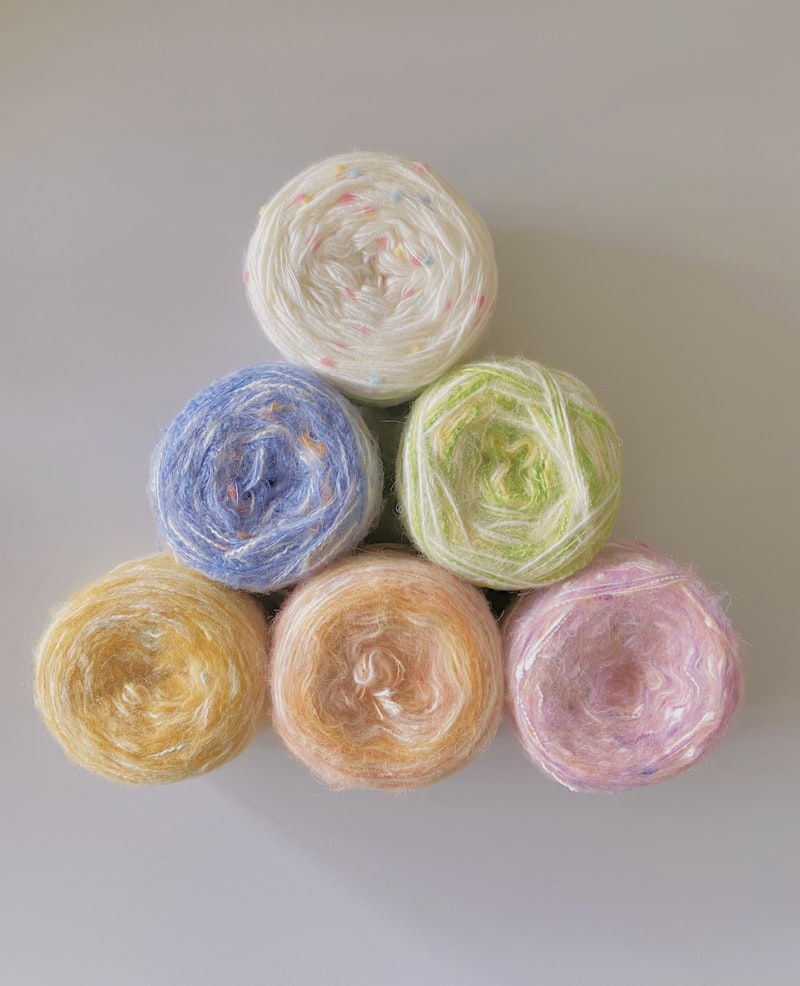 Four skeins of natural yarn stacked together — the raw material behind every Cicikim piece