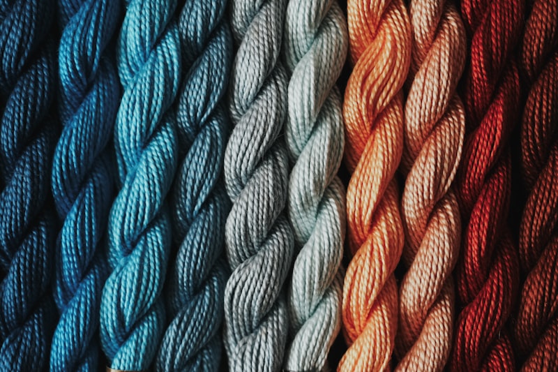 Close-up of colourful yarn threads in terracotta and cream tones