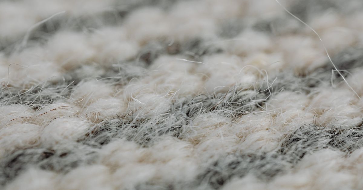 Detailed close-up of handmade woven wool textile showing warm texture